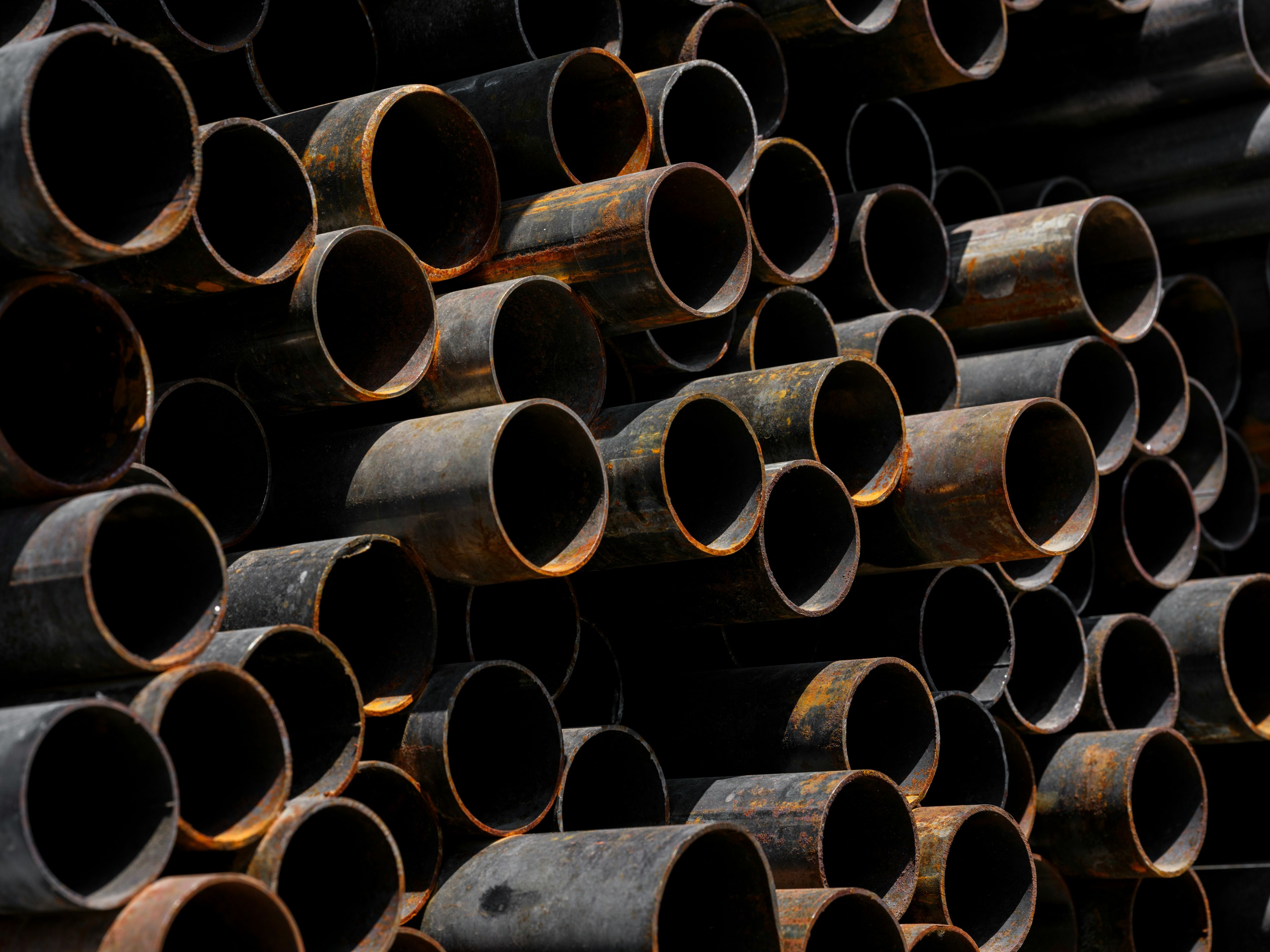 A large stack of pipes stacked on top of each other